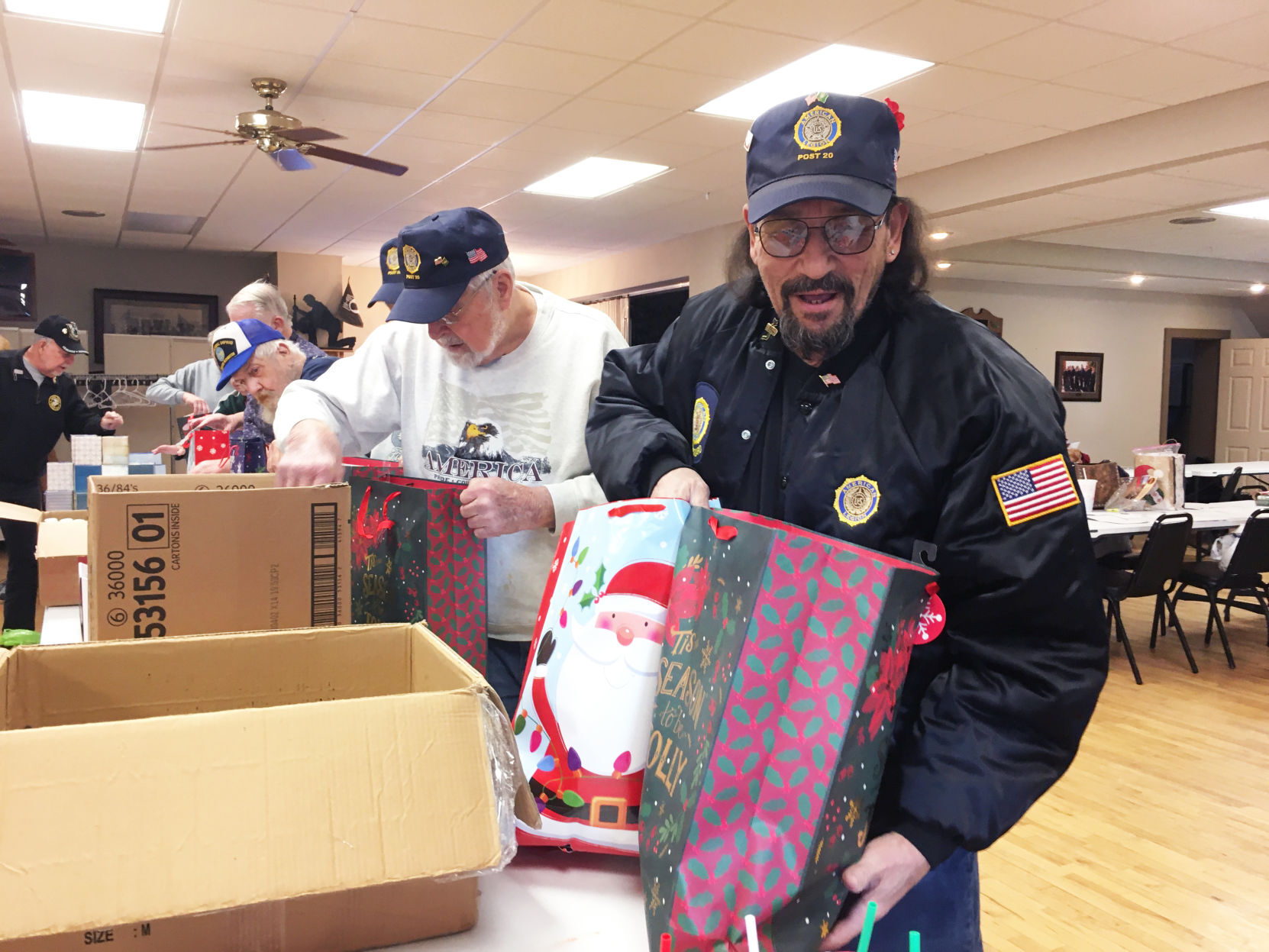 Conrado Moreno and other volunteers prepare gift bags for veterans home residents